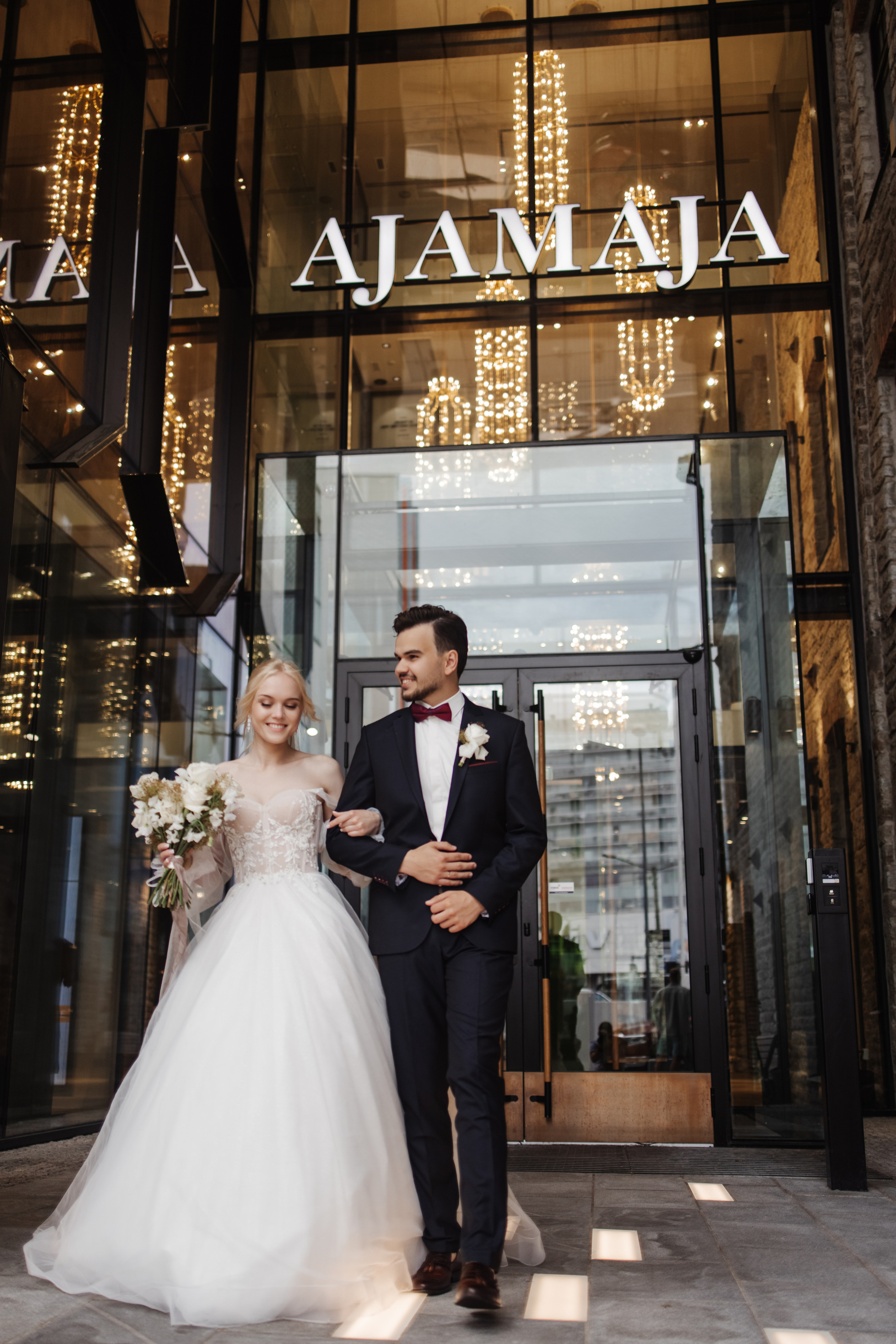 The bride and groom show wedding rings near the registry office in Tallinn
